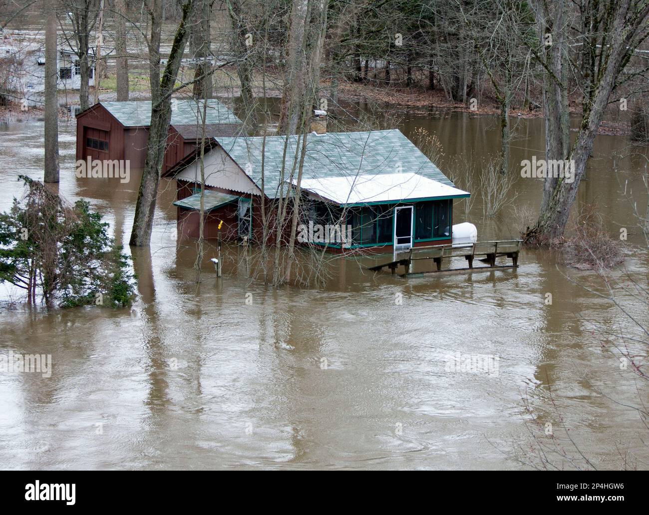 Water floods a home by the Muskegon River in Grant, Mich., Monday 