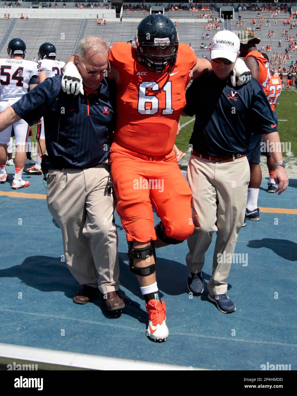 Virginia offensive tackle Cody Wallace (61) is helped off the field during  the NCAA college football, image size:1044x1390