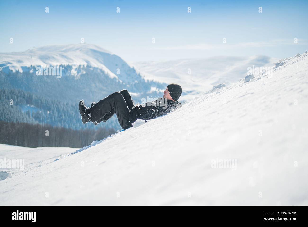 Man Sliding on Steep Slope in the Mountain Stock Photo - Alamy