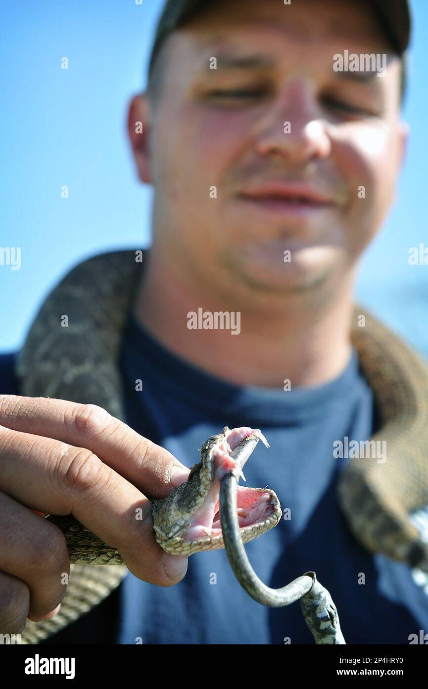 Volunteer firefighter Bobby Taylor uses a snake hook to display the