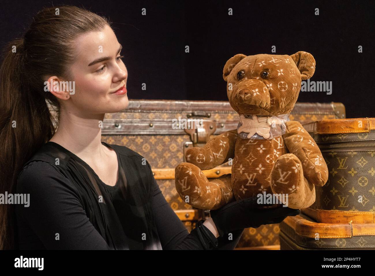 London, UK. 6 March 2023. An art handler holds a a DouDou 2005 & 2020 Teddy  Bear, Estimate £2,600 - £3,200 at the preview of Bonhams Designer Handbags  & Fashion Sale, The