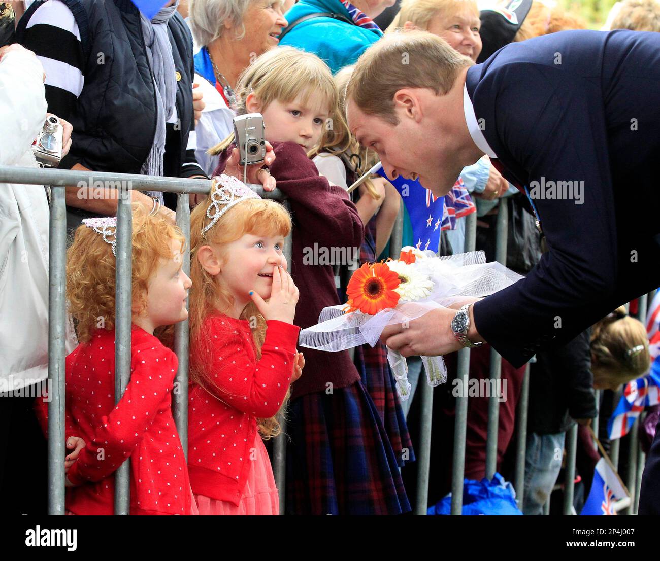 Britain's Prince William speaks with 3yearold twins Lola and Milly