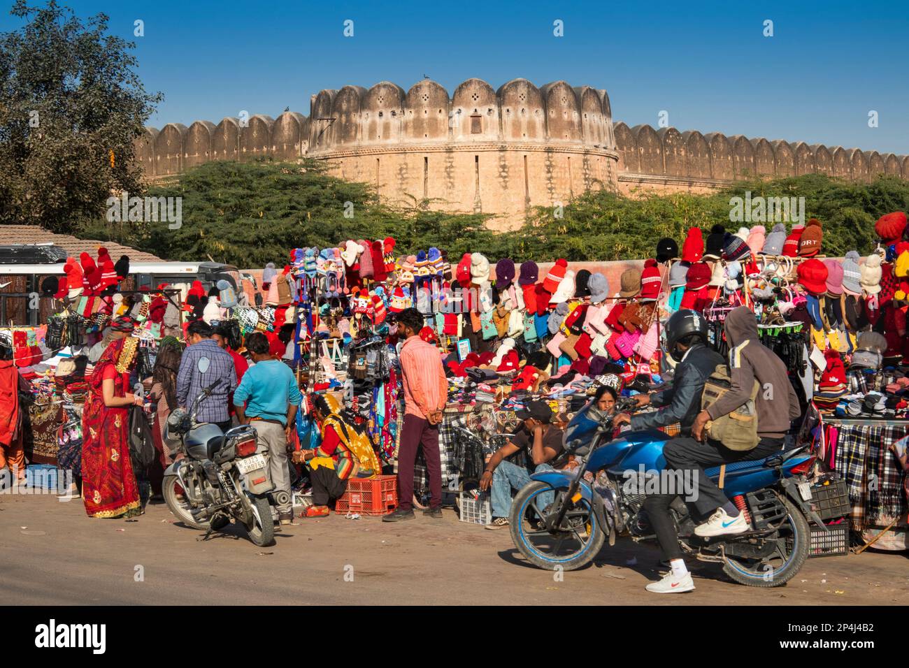 India, Rajasthan, Bikaner, clothes stalls below ramparts of Junagarh Fort Stock Photo