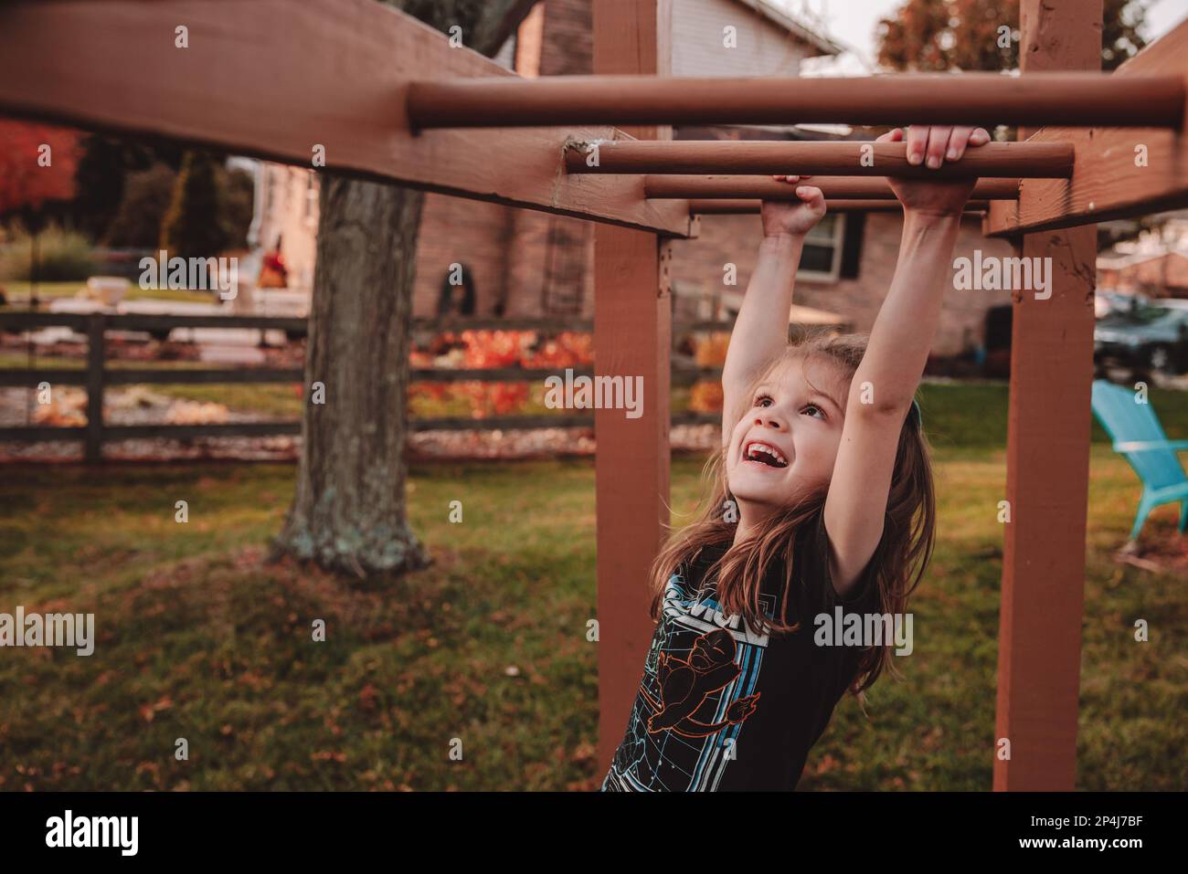 Learning how to go across the monkey bars Stock Photo Alamy