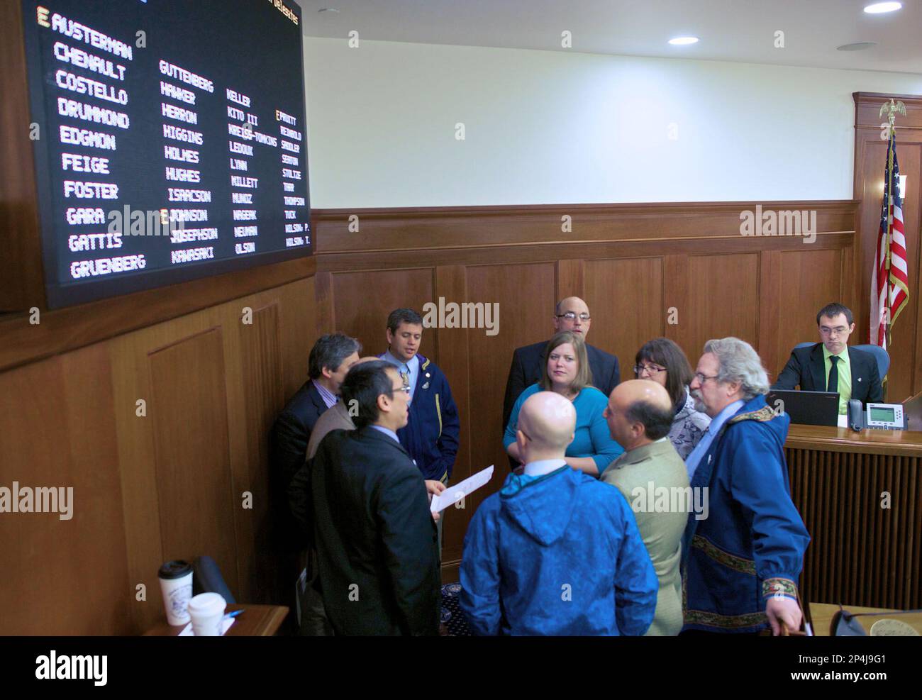 House Minority Caucus members huddle for discussions on the House floor