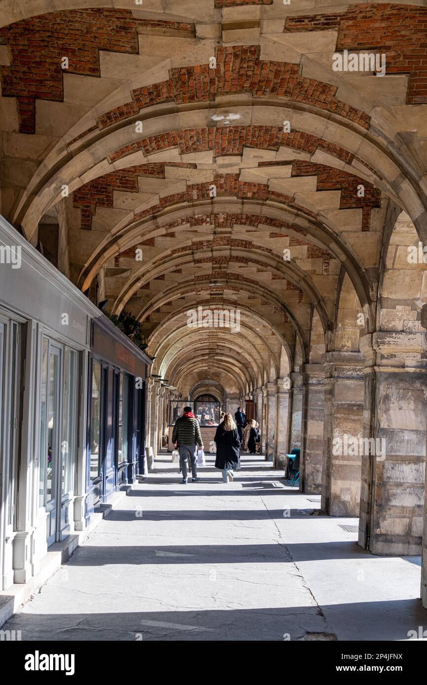 A tunnel of arches around the North Side of The Place Des Vosges, Marais, Paris. Stock Photo