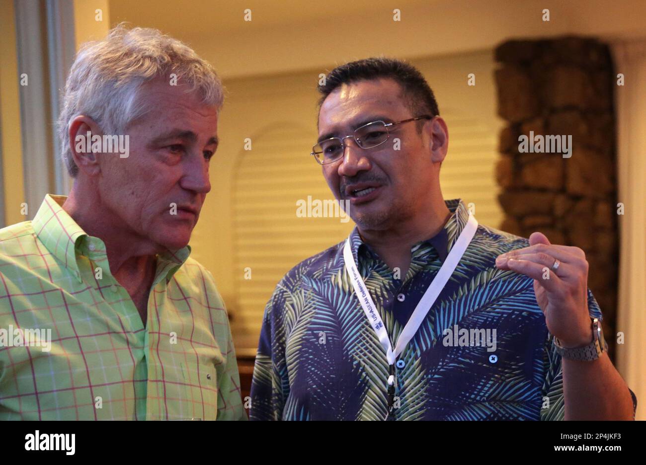 U.S. Secretary of Defense Chuck Hagel (L) listens to Malaysian Defence Minister and acting transport minister Hishammuddin Hussein (R) during a welcoming reception for Southeast Asian defense ministers April 1, 2014 in Honolulu, Hawaii. Secretary Hagel is in Hawaii to host a meeting of defense ministers from the Association of Southeast Asian Nations (ASEAN) on April 1 to 3. (AP Photo/POOL, Alex Wong) Stock Photo