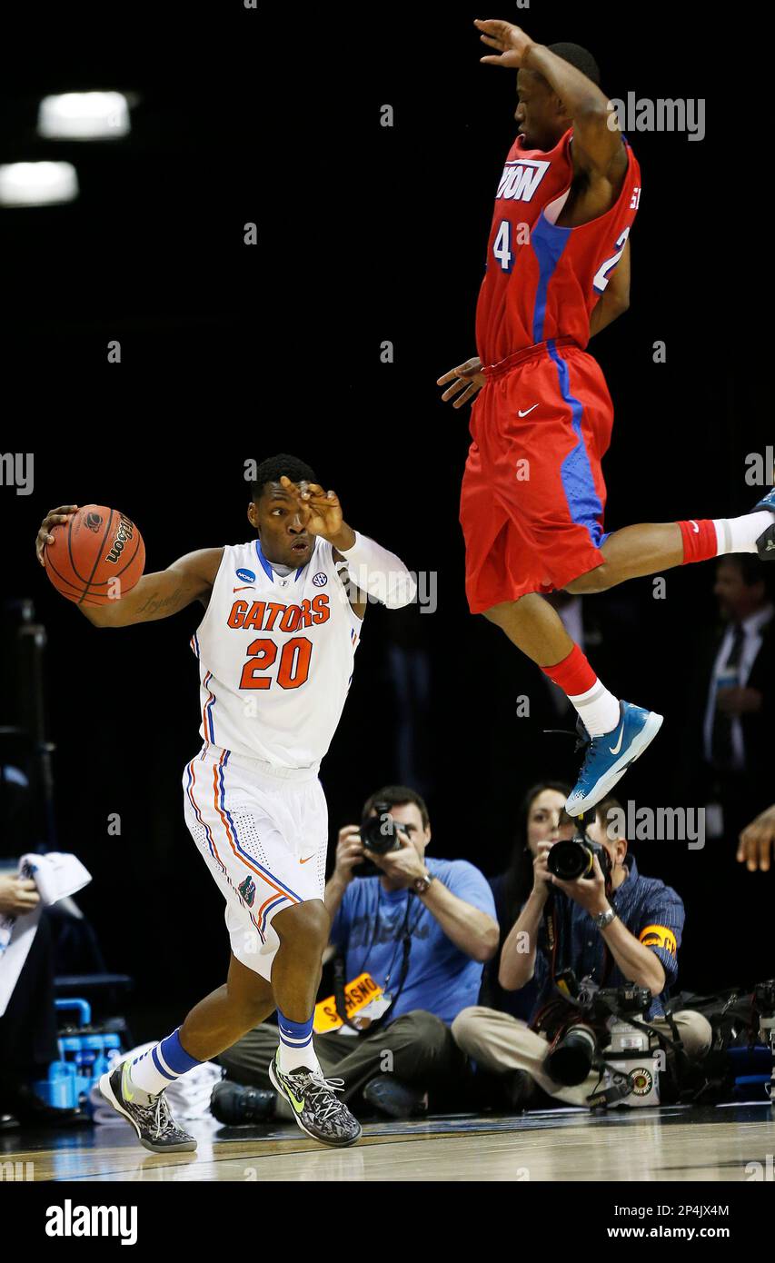 Florida guard Michael Frazier II (20) moves the ball by Dayton guard ...