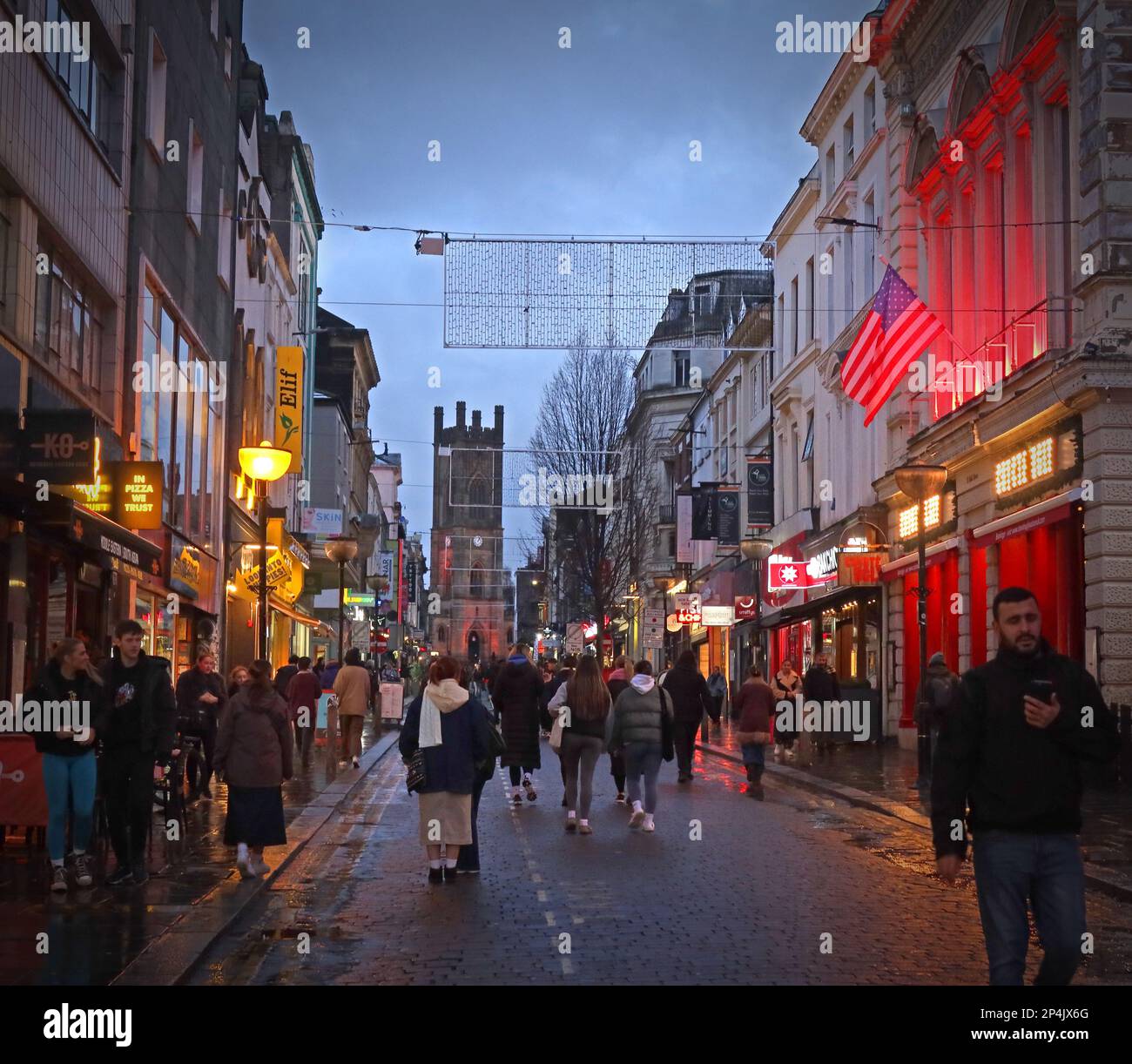 A busy Bold Street at dusk, Liverpool, Merseyside, England, UK, L1 4EZ,  Church of St Luke in the distance - the bombed out church Stock Photo