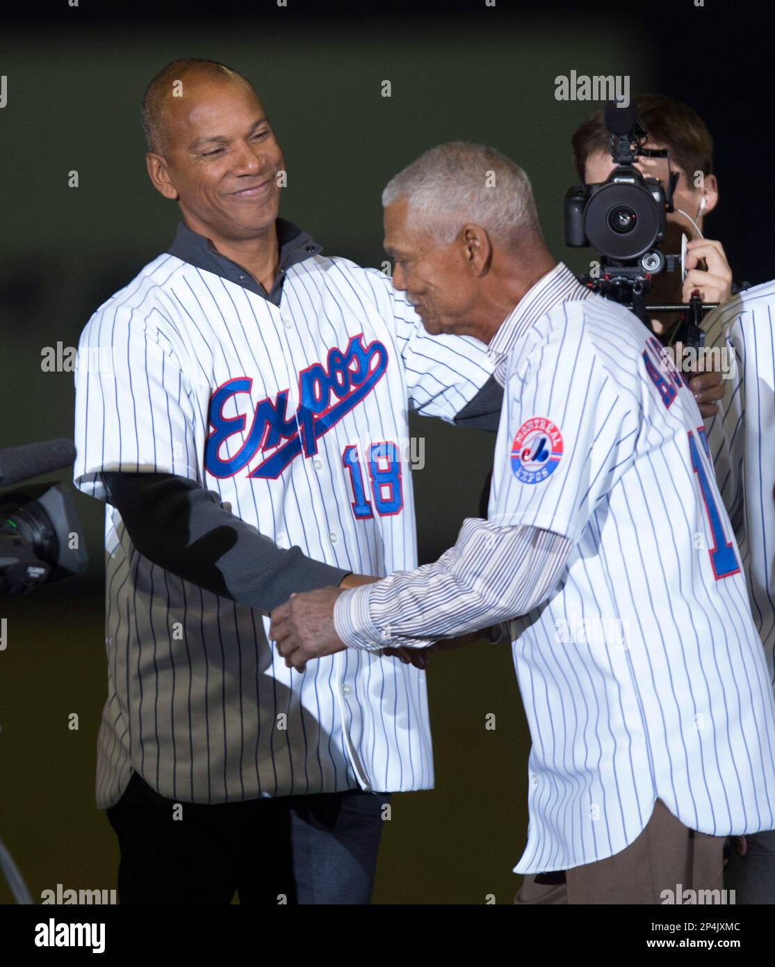 Former Montreal Expos manager Felipe Alou shakes hands with his son former  player Moises Alou as members of the 1994 team are introduced prior to a  exhibition baseball game between the Toronto