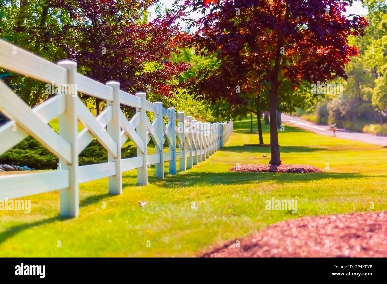 A crossbuck / cross buck style fence around the perimeter of a property in the US. Stock Photo