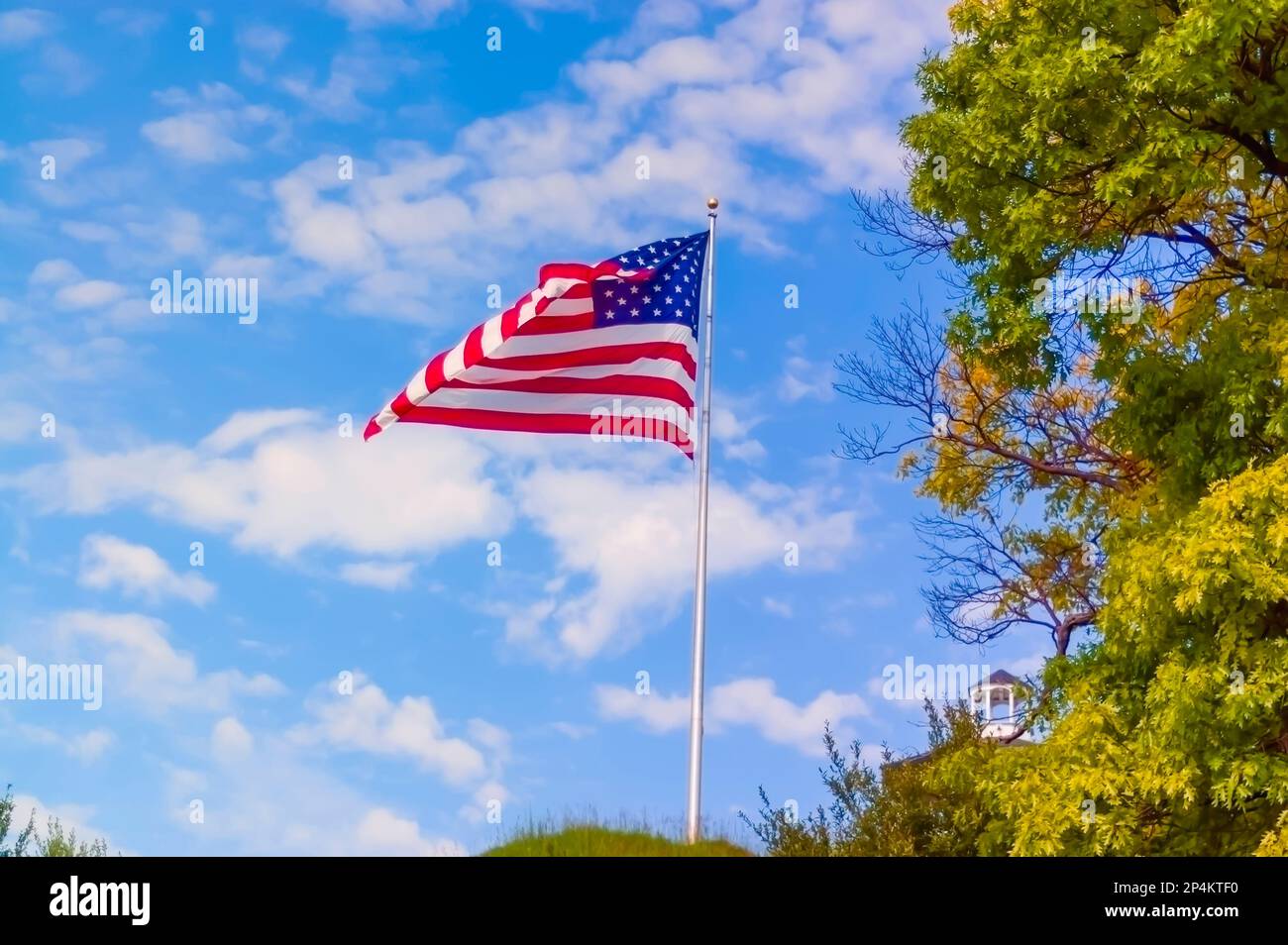 The American flag, star and stripes, fluttering in the wind on a summer morning. Stock Photo