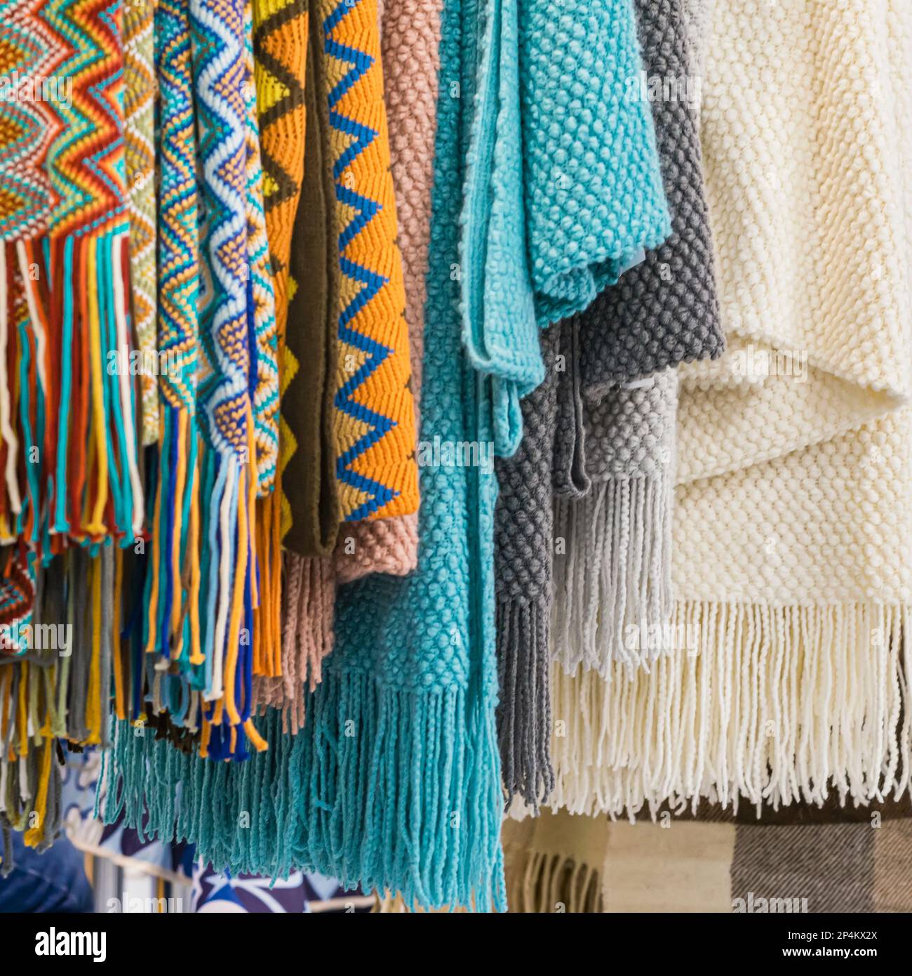 Several of warm rugs, stoles closeup. Cozy accessories for cold weather from natural material Stock Photo