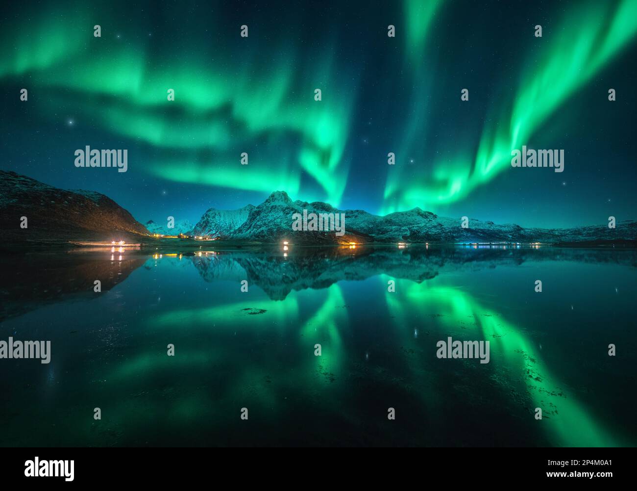 Northern lights over snowy mountains, sea, reflection in water Stock ...