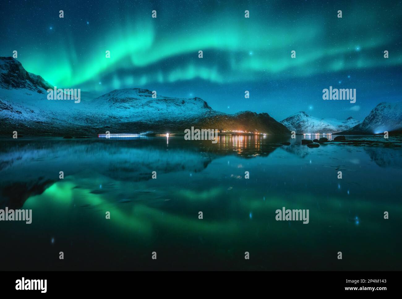 Northern lights over snowy mountains, sea, reflection in water Stock ...