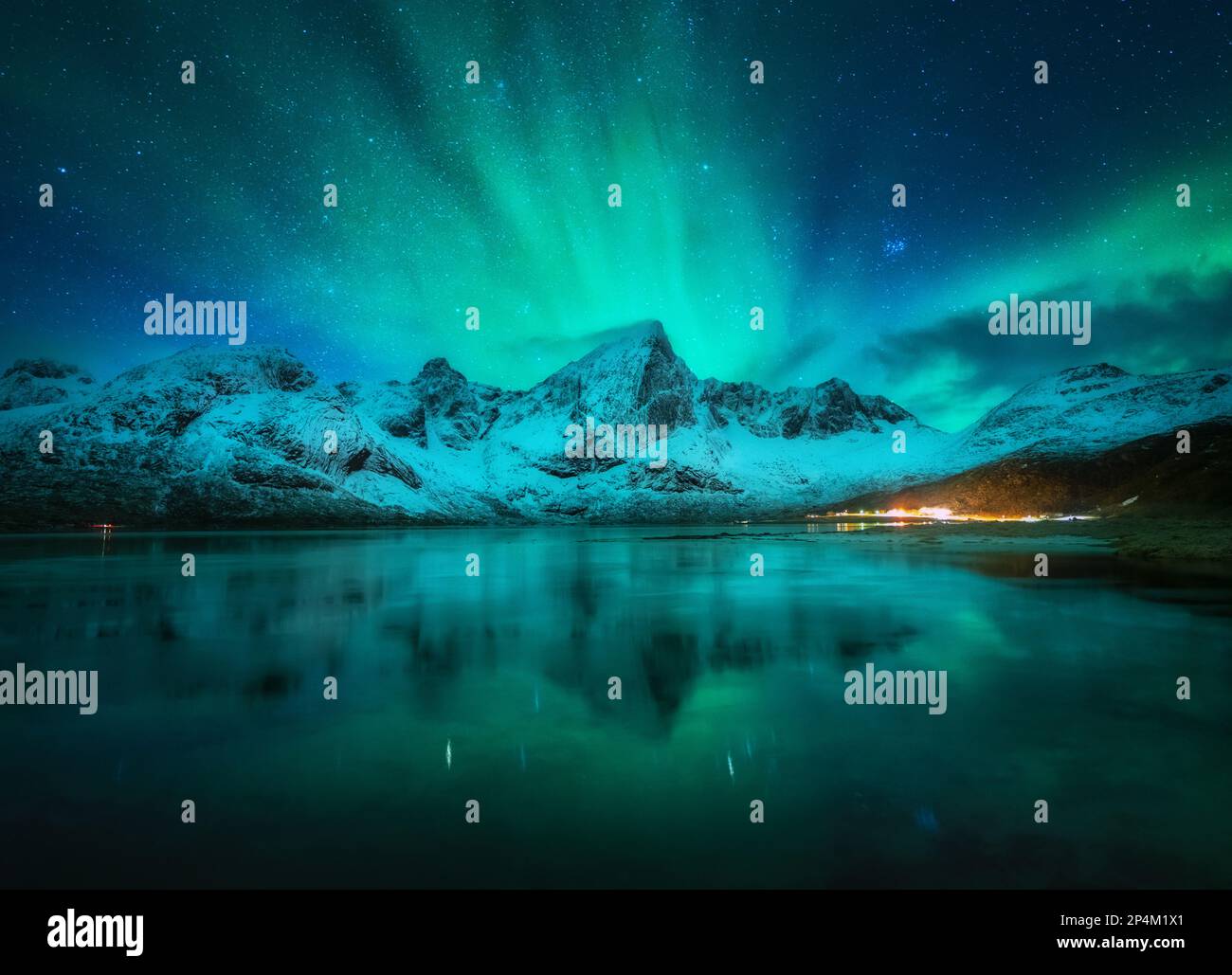 Northern lights over snowy mountains, sea, reflection in water Stock ...