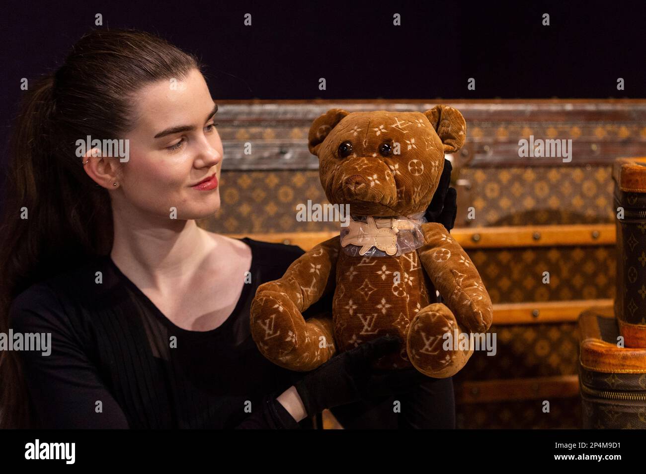 London, UK. 6 March 2023. A staff member presents 'a DouDou 2005 & 2020 Teddy Bear' by Louis Vuitton (Est. £2,600 - £3,200) at a preview of Bonhams’ Designer Handbags and Fashion sale which takes place at Bonhams’ Knightsbridge galleries on 9 March 2023. Credit: Stephen Chung / Alamy Live News Stock Photo