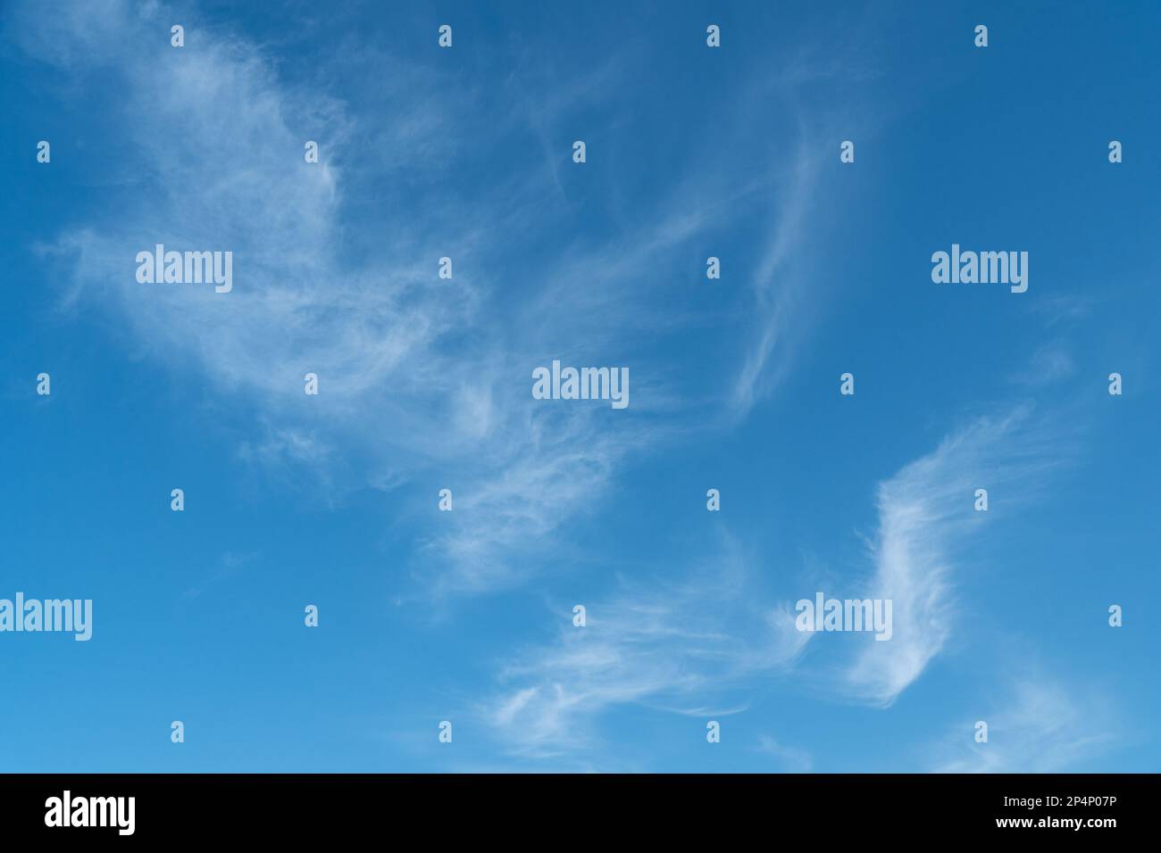 beautiful blue sky with some floating whispy clouds. Stock Photo