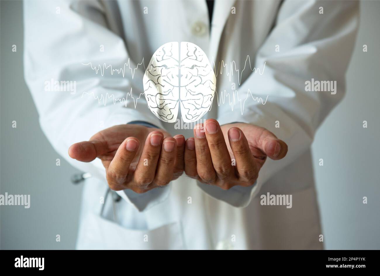 Doctor holding a brain model in his hands. Brain and brain waves ...