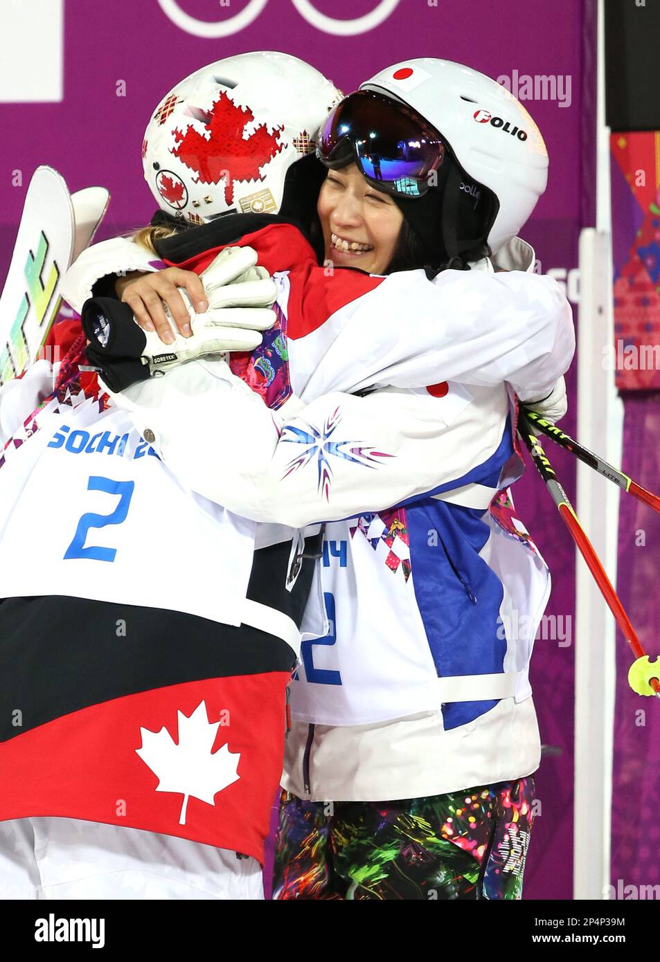 Aiko Uemura of Japan (R) celebrates after finishing fourth in the women's mogul final at Rosa Khutor in the Sochi Olympics on Feb. 8, 2014. 34-year-old Uemura, failed to earn the Olympic medal in her fifth Olympic. ( The Yomiuri Shimbun via AP Images ) Stock Photo