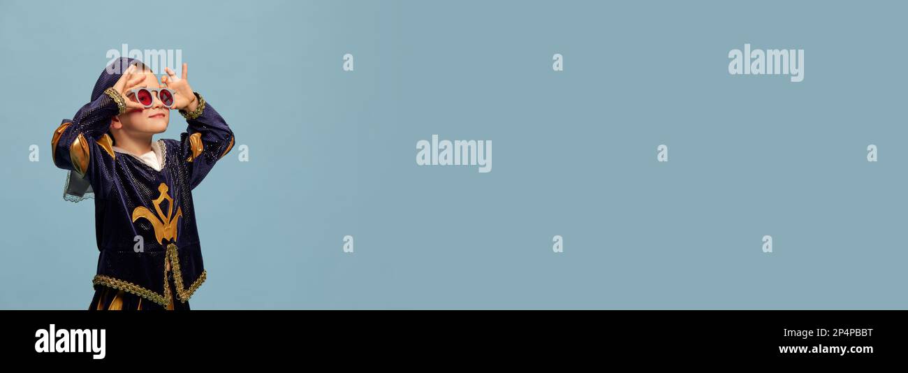 Portrait of little charming boy in costume of medieval pageboy, little