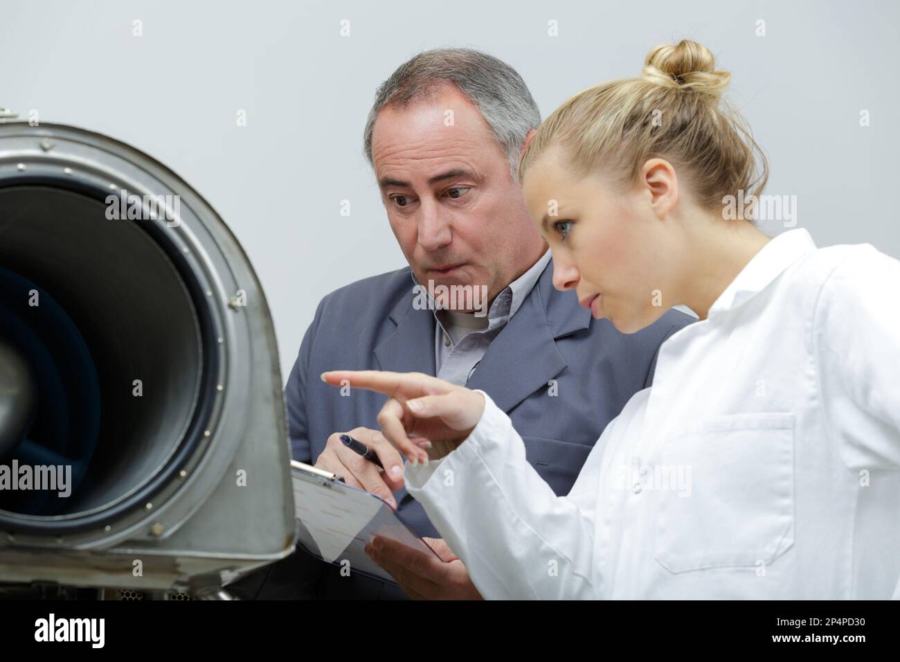 female jet engineer pointing at material Stock Photo - Alamy
