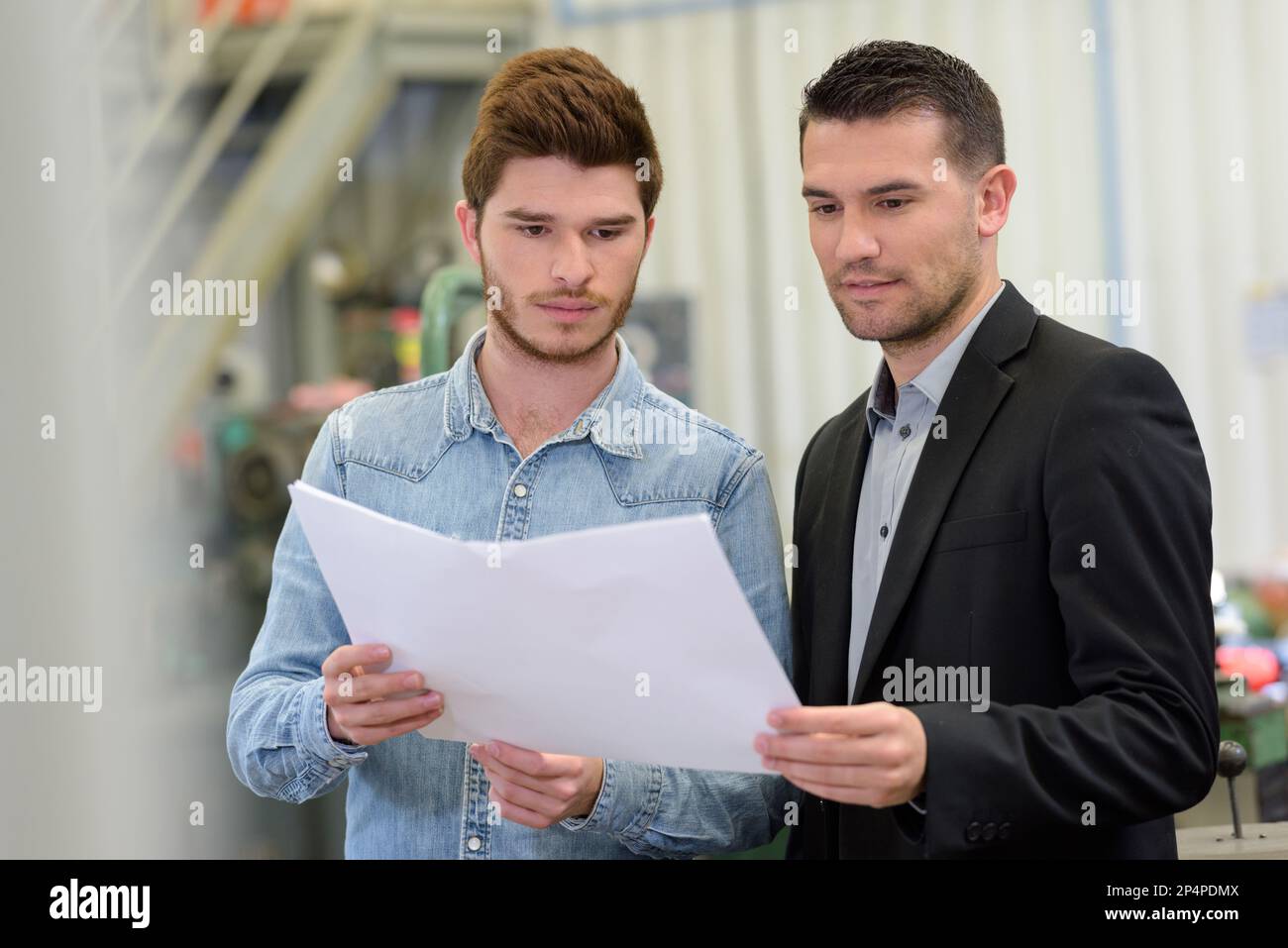 planning workers talking in factory Stock Photo