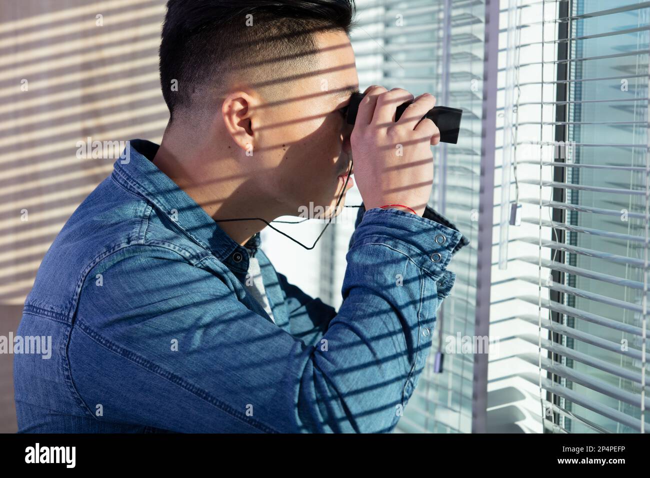 Man binoculars spying window hi-res stock photography and images - Alamy