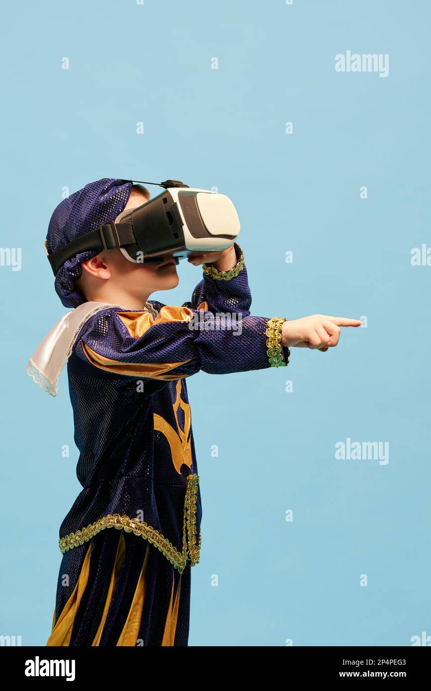 One little boy in costume of medieval pageboy, little prince wearing VR