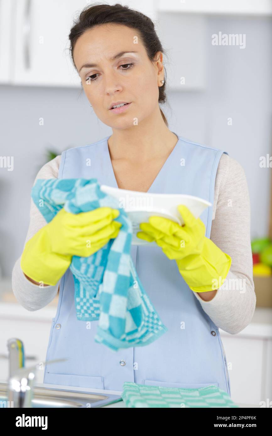 woman with gloves washing dishes Stock Photo
