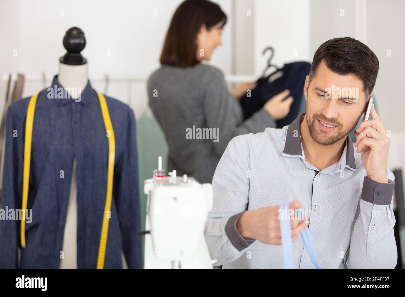 dressmaking design service worker talking on the phone Stock Photo