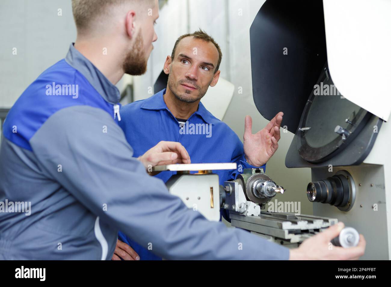 two workers at a manufacturing plant Stock Photo