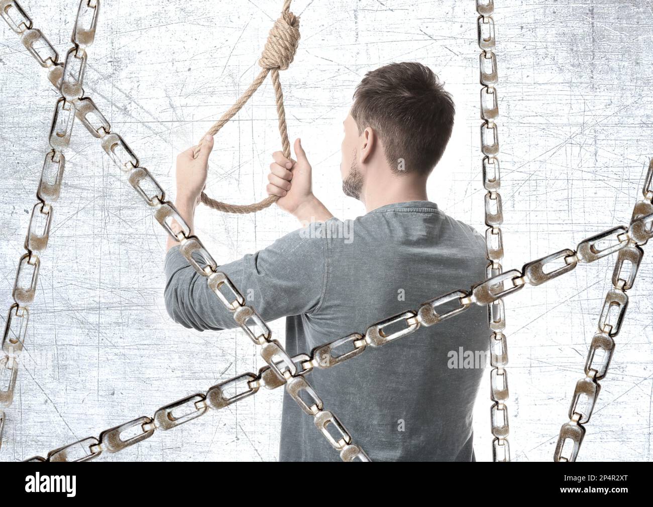 Man with rope noose and metal chains, back view Stock Photo - Alamy