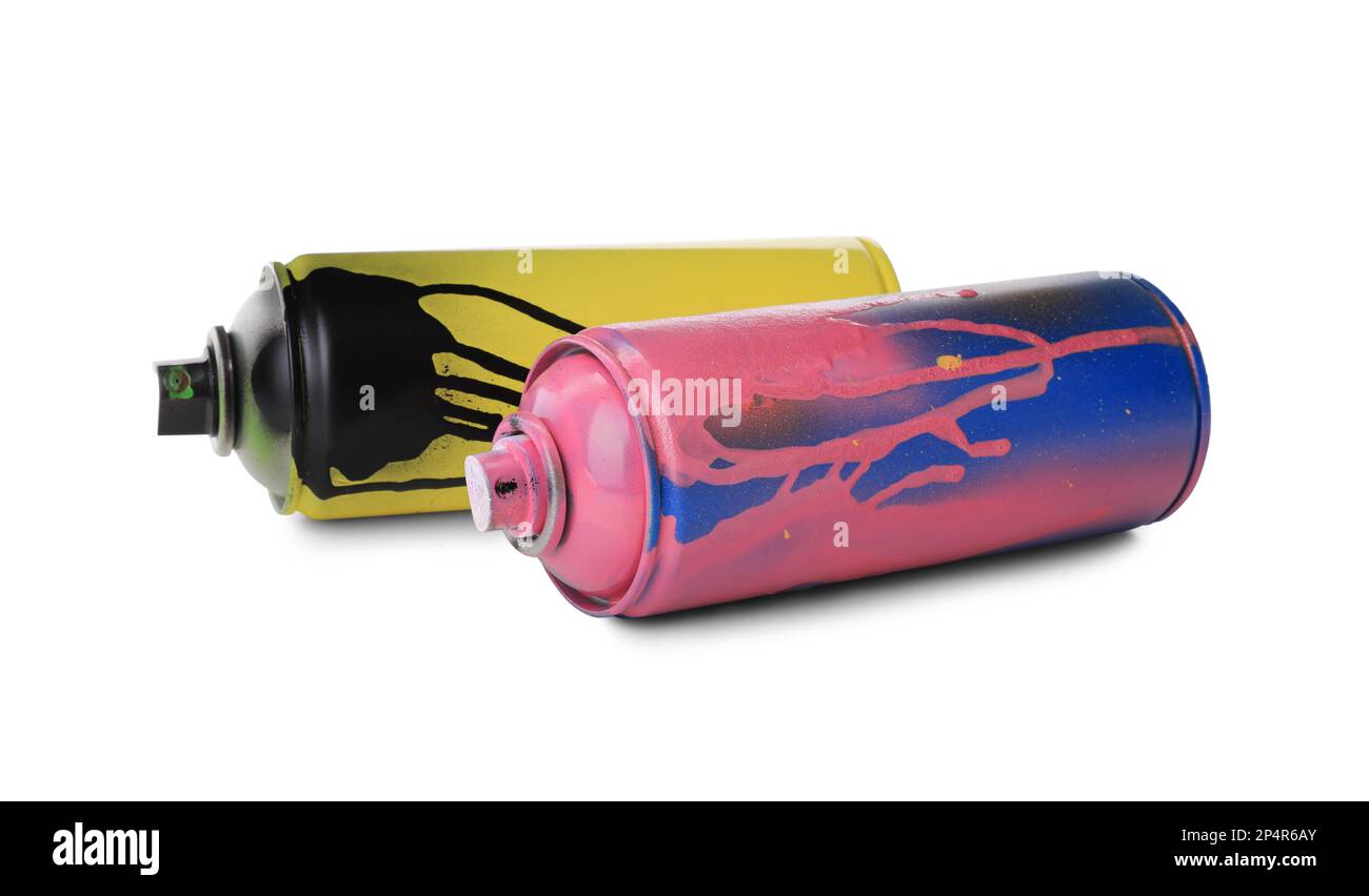 Some used pink aerosol spray cans with paint drips lies on a
