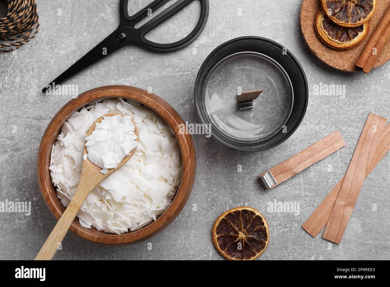 Flat lay composition with ingredients for homemade candles on grey ...