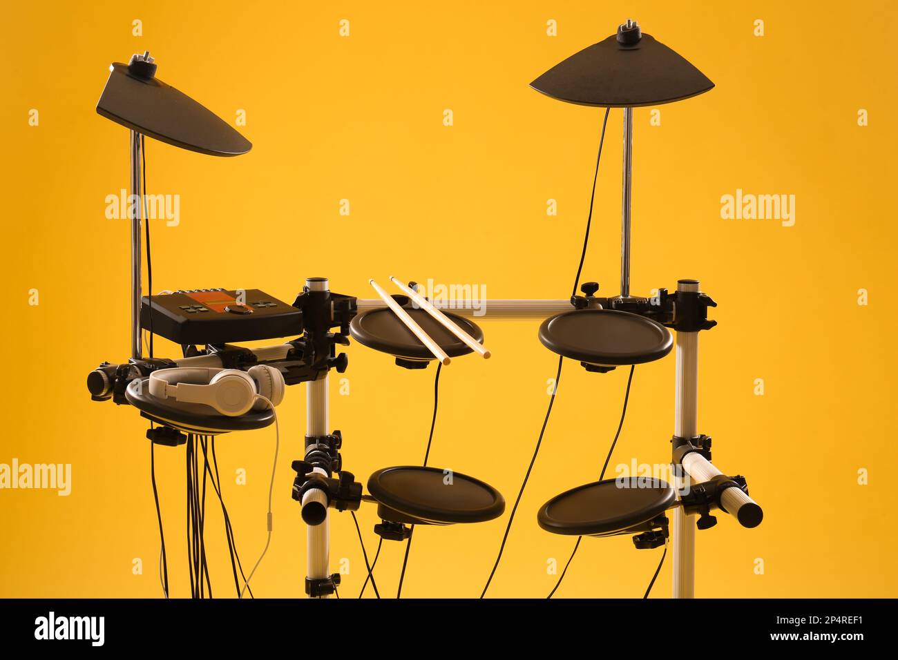 Modern electronic drum kit on yellow background. Musical instrument