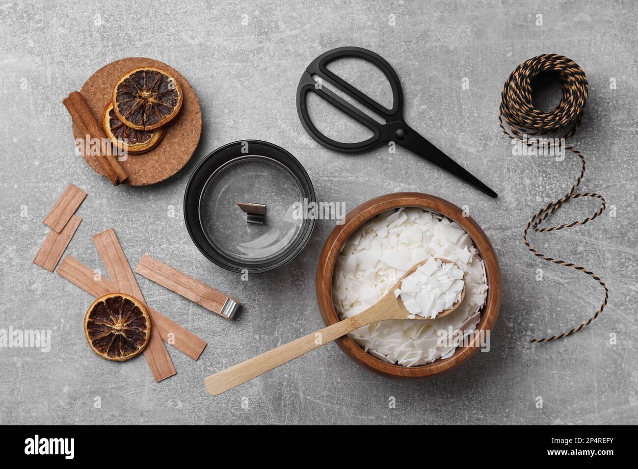 Flat lay composition with ingredients for homemade candles on grey ...