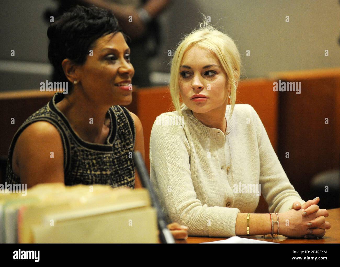 FILE - In this Dec. 14, 2011 file photo, Lindsay Lohan, right, alongside her attorney Shawn Chapman Holley appear during a progress report session at the Los Angeles Superior Court, in Los Angeles. A star of Disney films whose acting received early praise and attention, Lohan’s 2007 two arrests for DUI and drug possession still haunts the actress today. While the 27-year-old has put those cases behind her, she remains on probation for a necklace theft case and lying to police about her role in a crash on Pacific Coast Highway. (AP Photo/Michael Nelson, Pool, File) Stock Photo