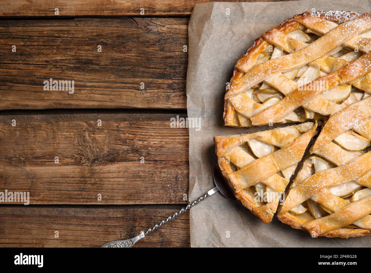 Delicious traditional apple pie on wooden table, top view. Space for text Stock Photo