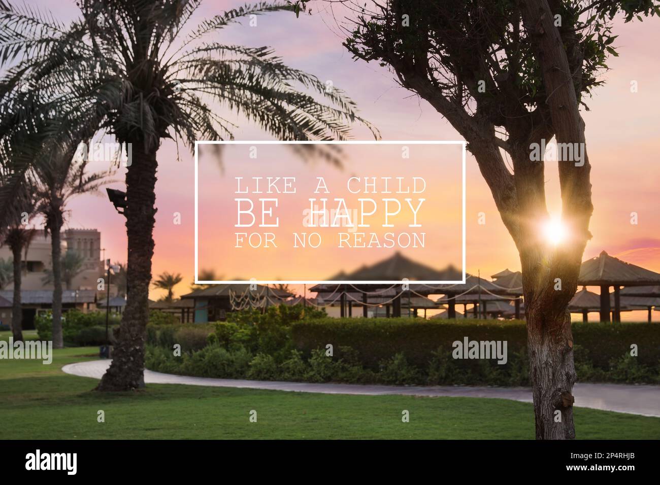 Like A Child, Be Happy For No Reason. Inspirational quote saying that you don't need anything to feel happiness. Text against beautiful view of tropic Stock Photo