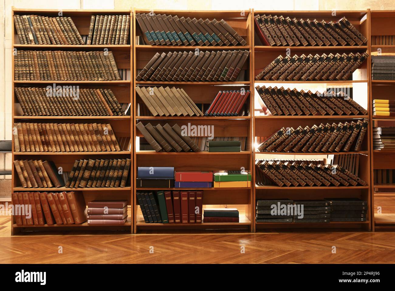 Collection of different books on shelves in library Stock Photo Alamy