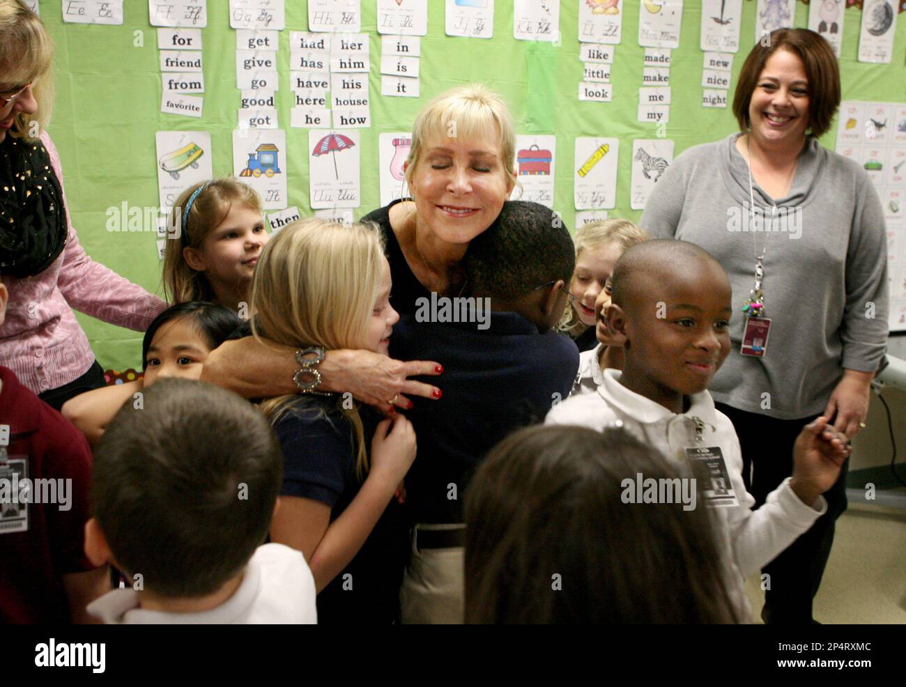 Florida first lady Ann Scott, center, gets hugs from Tracey Echevarria