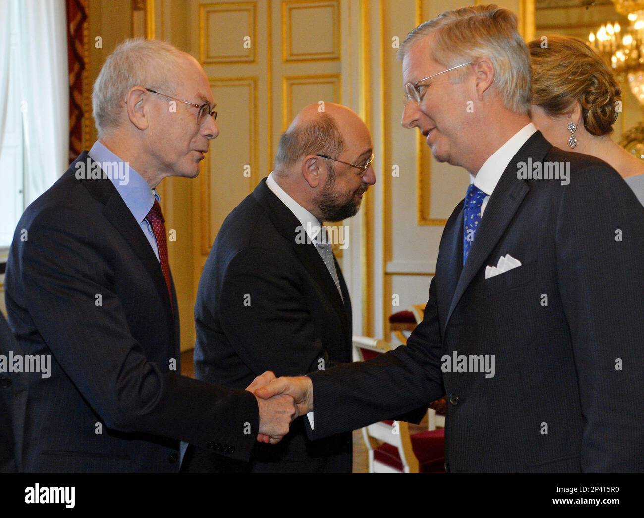 Belgium's King Philippe, right, shakes hands with European Council President Herman Van Rompuy, during a New Year's reception at the Royal Palace in Brussels, Friday Jan. 10, 2014. Belgium's King Philippe invited EU officials from all the EU institutions in Brussels, for the annual New Year's reception. (AP Photo/Eric Lalmand, pool) Stock Photo