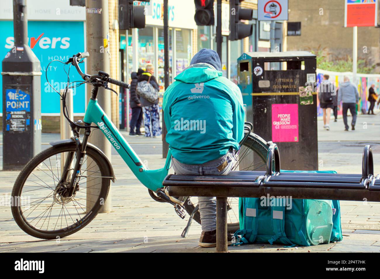 Glasgow, Scotland, UK 6th March, 2023. UK Weather: Deliveroo cyclist Sunny start saw happier locals as the streets filled in the spring weather before the forecast return of winter. Sauchiehall street in the sun.  Credit Gerard Ferry/Alamy Live News Stock Photo