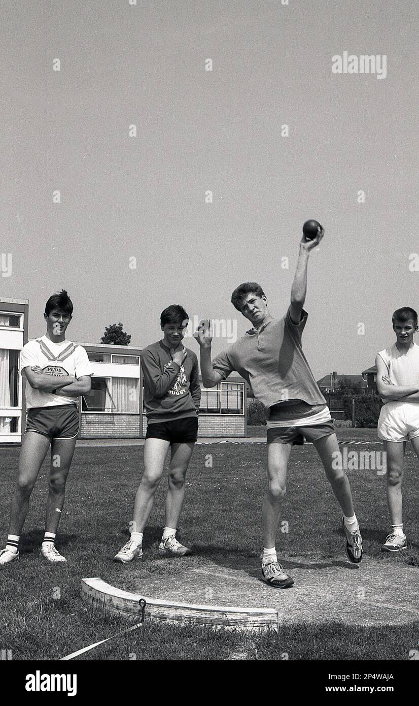 1989, histocal, secondary school sports day, a lefthanded schoolboy doing the shot put, watched