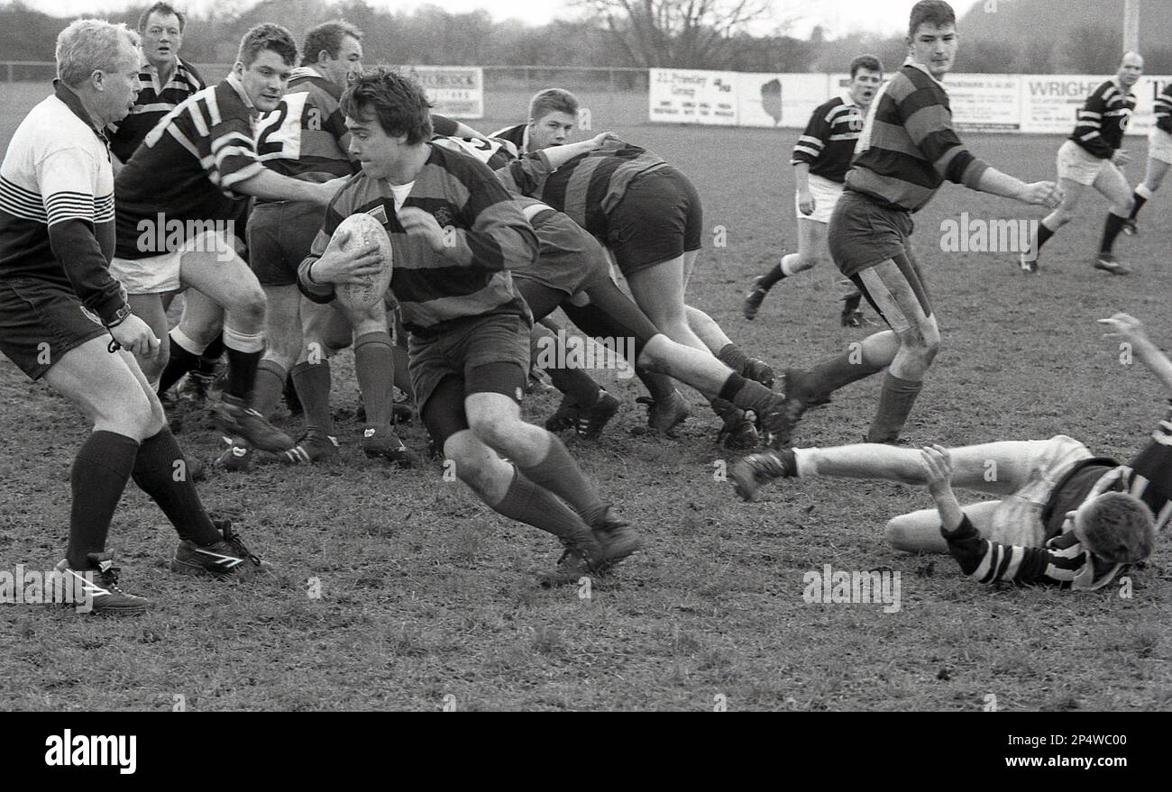 1980s, amateur rugby union match, from a scrummage, a male rugby player, the scrumhalf, moving away with ball in hand, England, UK. Stock Photo