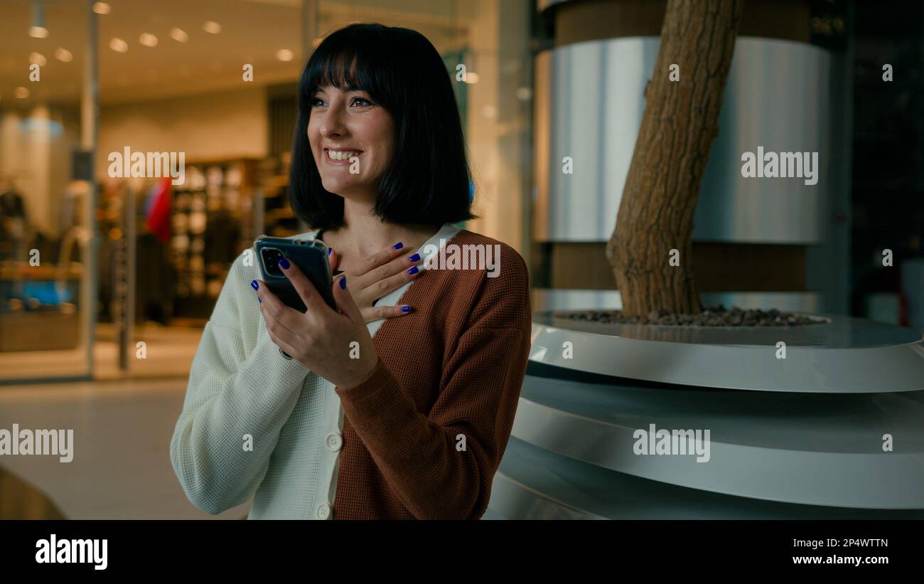 Happy amazed woman female girl win with mobile phone bet browsing, winning celebrating cellphone success triumph chatting communication with Stock Photo