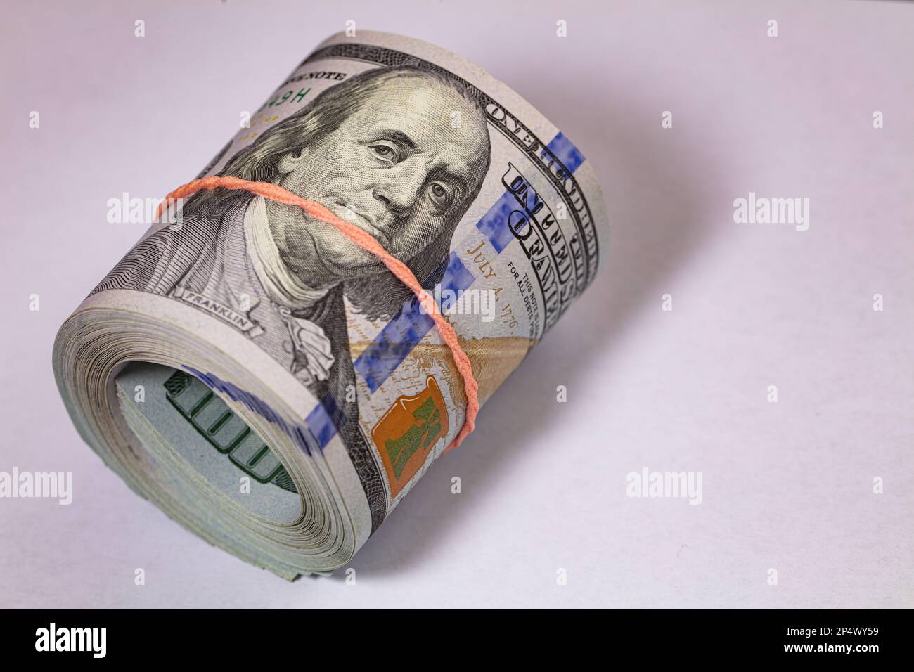 roll of 100 dollar banknotes on white background for design purpose ...