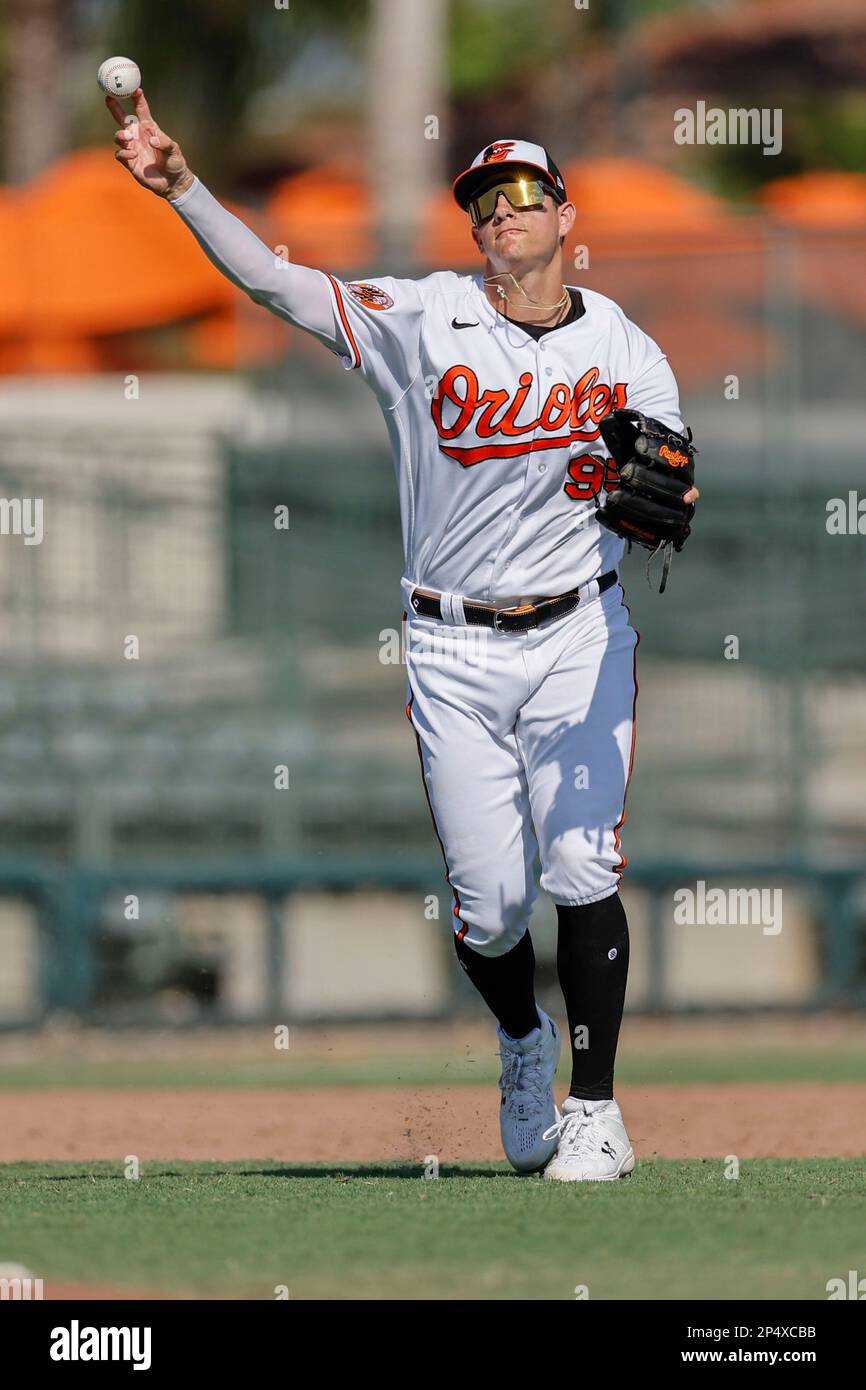 Sarasota FL USA; Baltimore Orioles infielder Coby Mayo (95) fields a ball and throws to first during an MLB spring training game against the Atlanta B Stock Photo