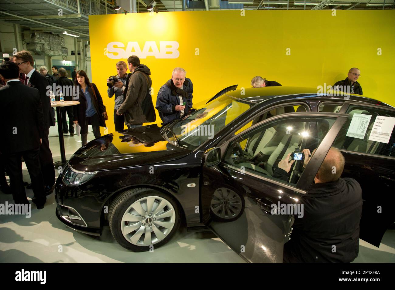 Reporters look at the first production Nevs (National Electric Vehicle